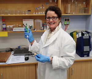 Doctor in white lab coat smiling at camera