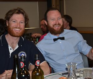 Two seated expeditioners smiling at the camera