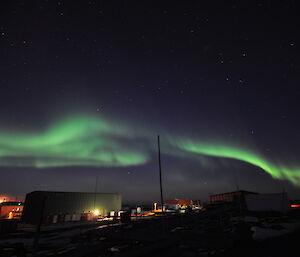 Green aurora in the night’s sky above Davis station