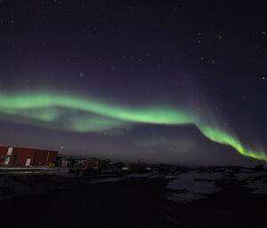 Green aurora in the night sky over Davis station