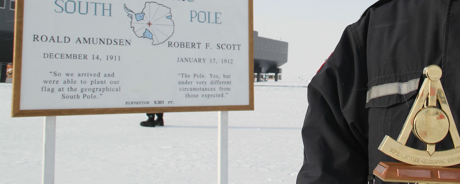 Man standing next to the South Pole