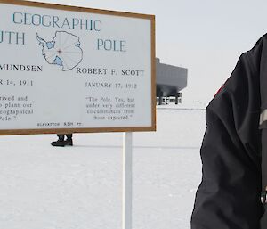 Man standing next to the South Pole