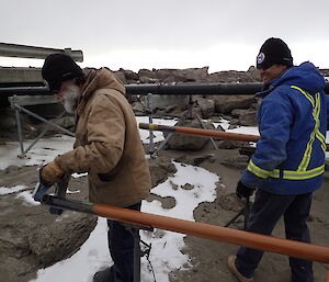 Expeditioners working on fuel lines