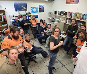 Expeditioners gathered inside a room at a pre-dinner party