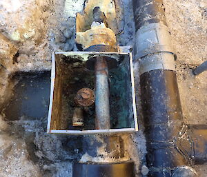 Photo of pipework in the ground looking muddy and dirty