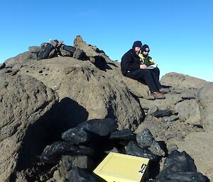 Two expeditioners standing on a hilltop