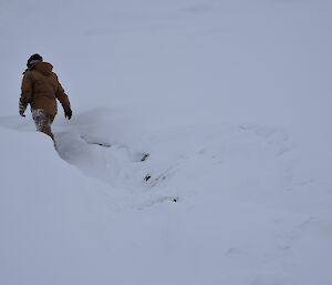 Expeditioner wading through knee deep snow