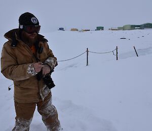 Expeditioner taking notes outside following a seal count