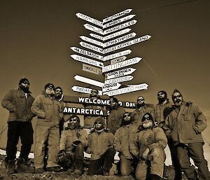 Group of bearded photographers stand in front of Davis signpost