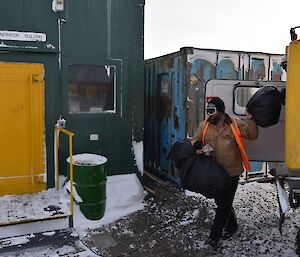 Expeditioner carrying burnable waste to an incinerator