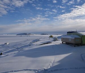 Old station infrastructure with sea ice in background