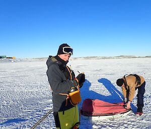 Expeditioner recording sea ice measurements