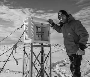 Expeditioner conducting observations of a weather instrument
