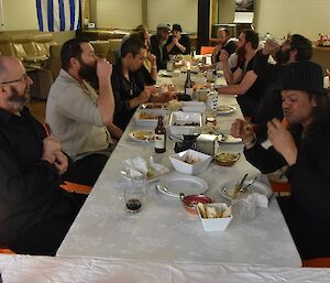 Expeditioners seated at a long table celebrating a meal together