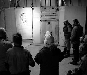 Expeditioners gathered around the makeshift electrics display