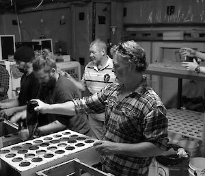 Expeditioners form a line washing bottles