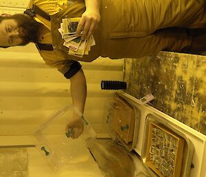 Expeditioner standing with seedings, seeds and empty seed beds in the hydroponic shed