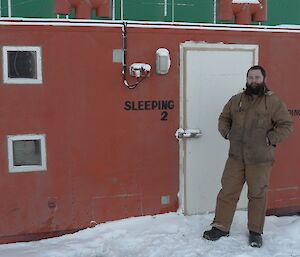 expeditioner posing for a photo outside the red hydroponics container