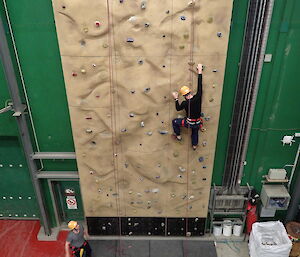 expeditioner mid way up the climbing wall