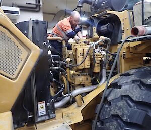Expeditioner mechanic working on a loader in the diesel workshop