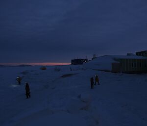 members of the station search teams visually inspect areas around the living quarters in the darkness