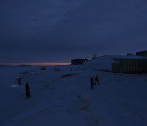 members of the station search teams visually inspect areas around the living quarters in the darkness