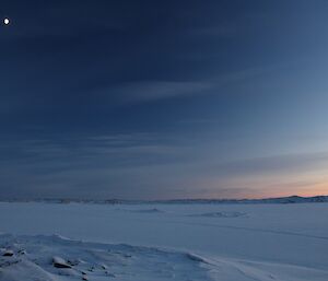 The moon above antarctic landscape