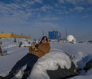 Expeditioner reclining in foreground. Bureau of Meteorology building at rear