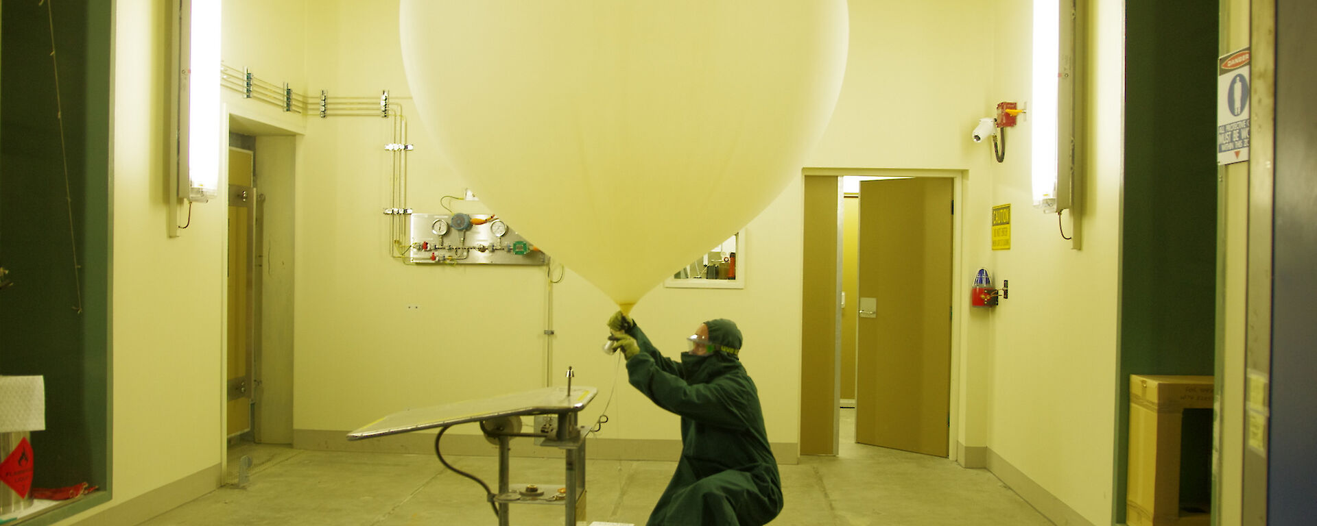 Expeditioner in protective gear tying off of the ozone sonde