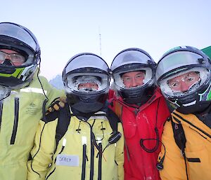 Four expeditioners facing camera with helmuts on