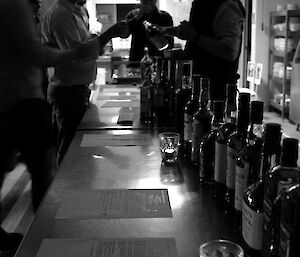 Expeditioner pouring a sample of whisky for another expeditioner