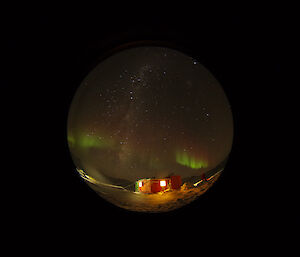 Green Aurora hanging in the night’s sky over Watts hut