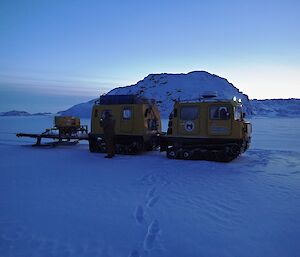 Yellow Hägglunds tracked vehicle on sea ice