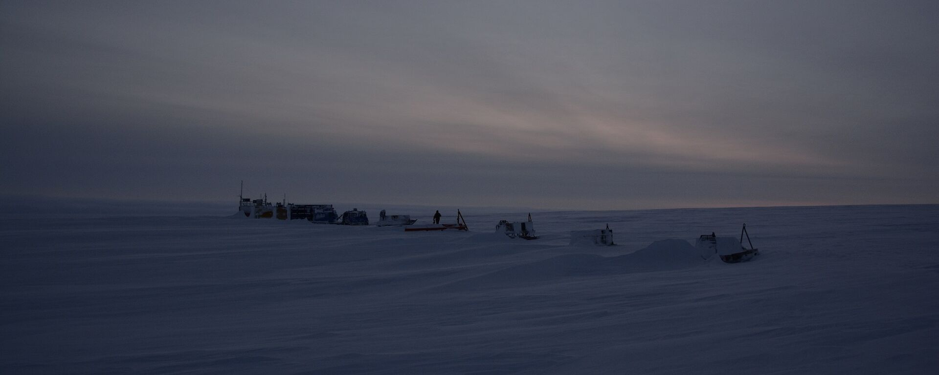 Remote camp with a series of modules spaced evenly in a line on ice