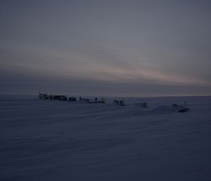 Remote camp with a series of modules spaced evenly in a line on ice