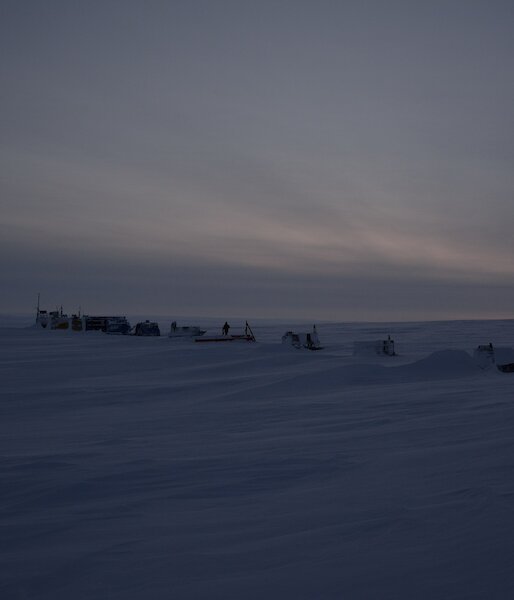 Remote camp with a series of modules spaced evenly in a line on ice