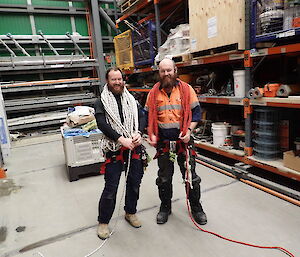 Two expeditioners carrying ropes facing towards camera