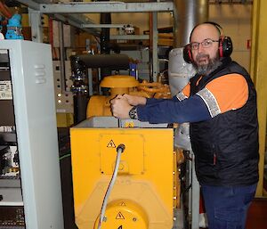 Expeditioner facing camera working in main power house of station