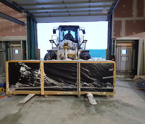 Expeditioner driving a loader towards camera