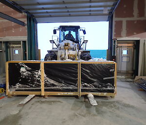 Expeditioner driving a loader towards camera