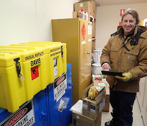 Expeditioner taking a photo of a large yellow container