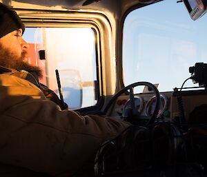 A still taken from film of expeditioner driving a tracked vehicle