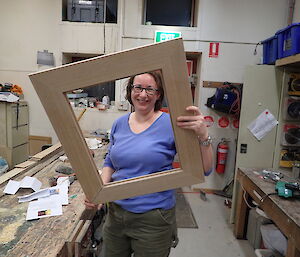 Expeditioners holding a picture frame in front of the camera