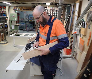 Expeditioner standing beside a work bench