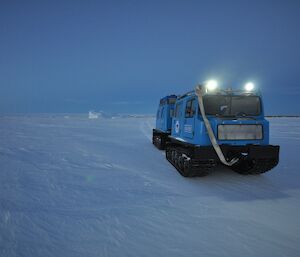 Blue Hägglunds tracked vehicle being put through its paces