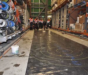 Expeditioner slides an ice ‘stone’ down a makeshift curling lane