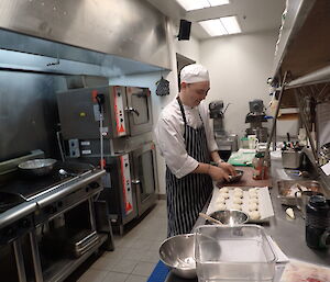 Chef smiling in the kitchen.