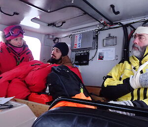 Doctor at left assesses to expeditioners seated inside a Hagg vehicle