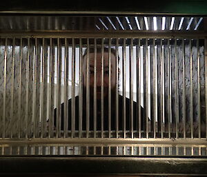 Expeditioner standing behind a grill
