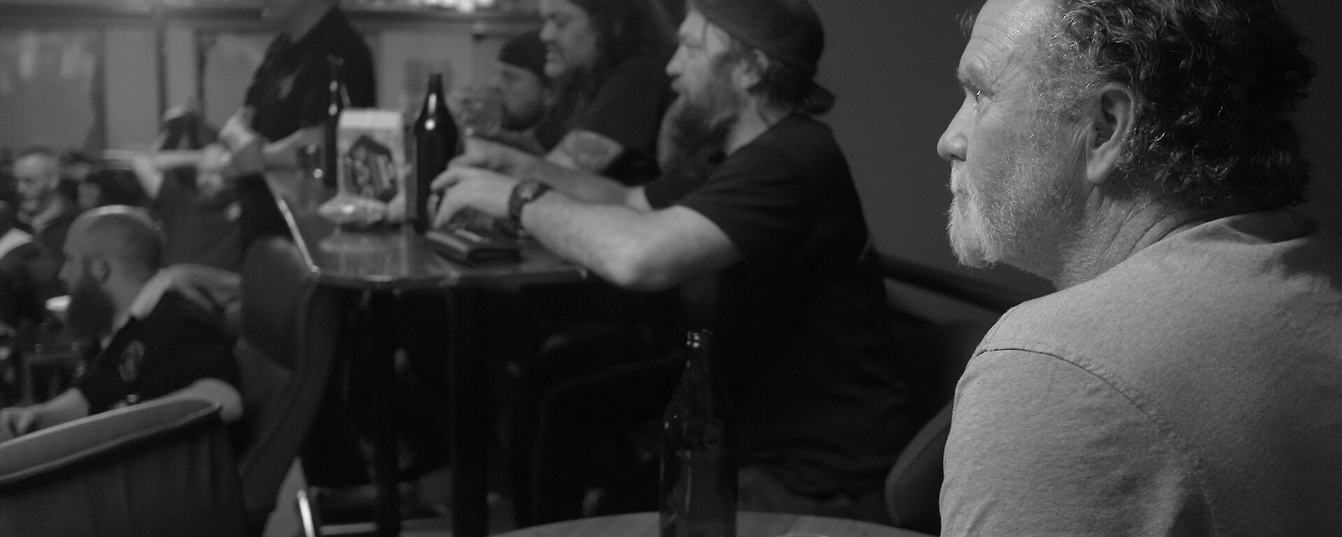 Expeditioner in foreground watching the darts tournament